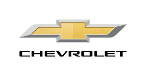 LED sign displays Chevrolet gold bowtie emblem with silver trim above bold black CHEVROLET text on white, high-brightness panel.