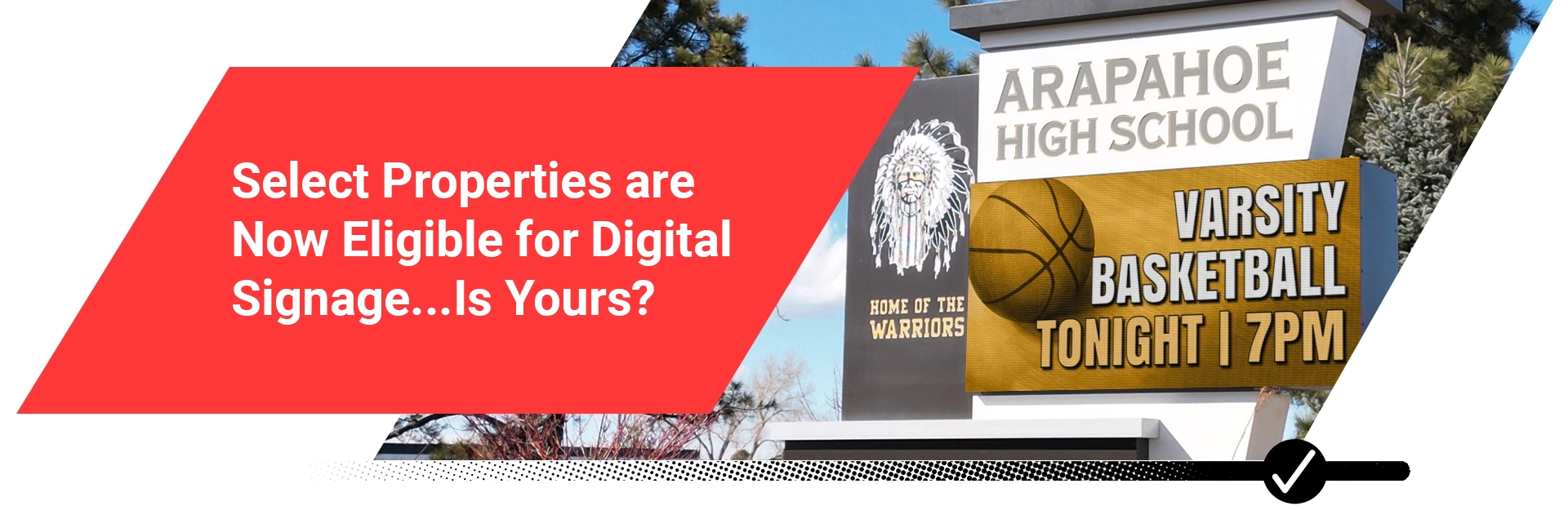 An LED electronic message center outside Arapahoe High School reads: Varsity Basketball Tonight 7PM, with digital overlay on red background.