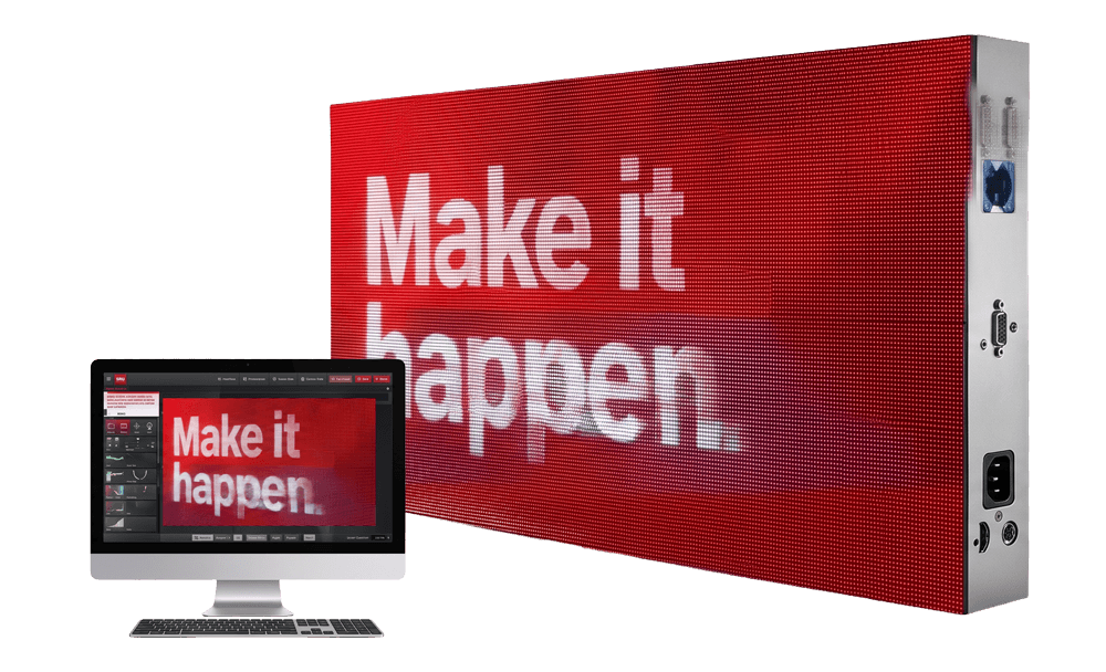 A computer monitor and a high-brightness solid-state LED electronic message center both display "Make it happen" in bold white on red.