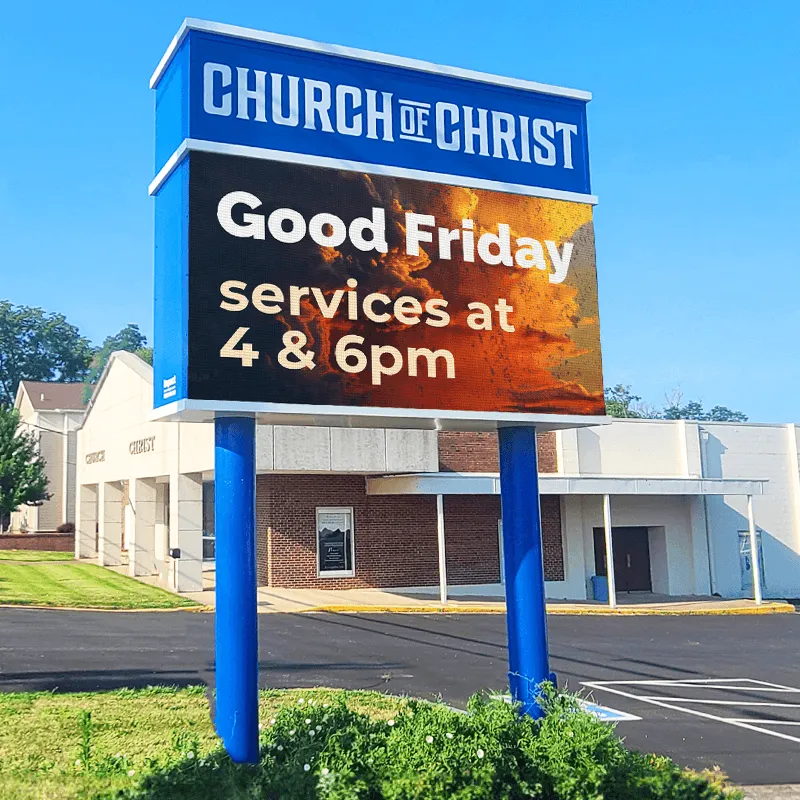 ONYX an LED electronic message center in front of a Church of Christ displays Good Friday service times at 4 & 6pm with a graphic background. The solid-state, high-brightness sign stands before the church building under a clear blue sky.