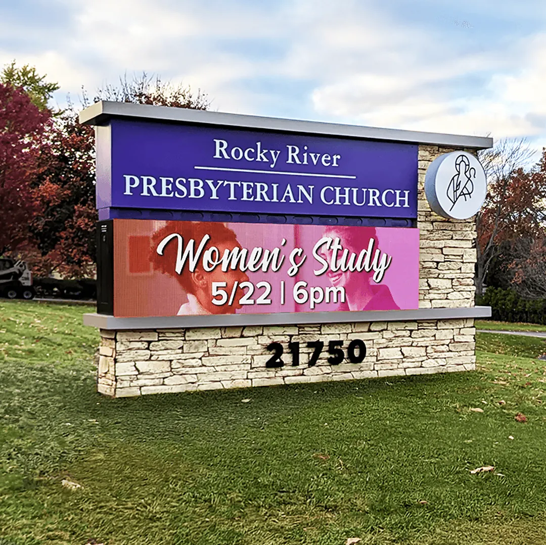 An LED electronic message center for Rocky River Presbyterian Church displays “Women’s Study 5/22, 6pm.” The sign is mounted on a stone base with grass and trees behind it, and the street address 21750 is visible.