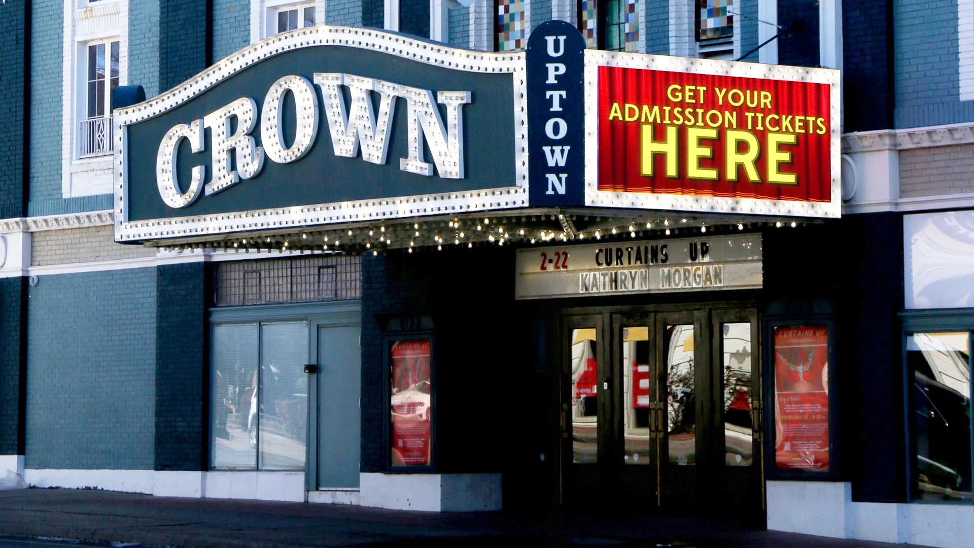 Crown Uptown Theatre marquee with a red LED display reading “Get your admission tickets here.”