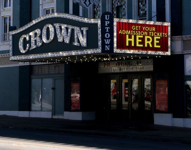 Crown Uptown Theatre marquee with an LED display reading “Get your admission tickets here” above the entrance.